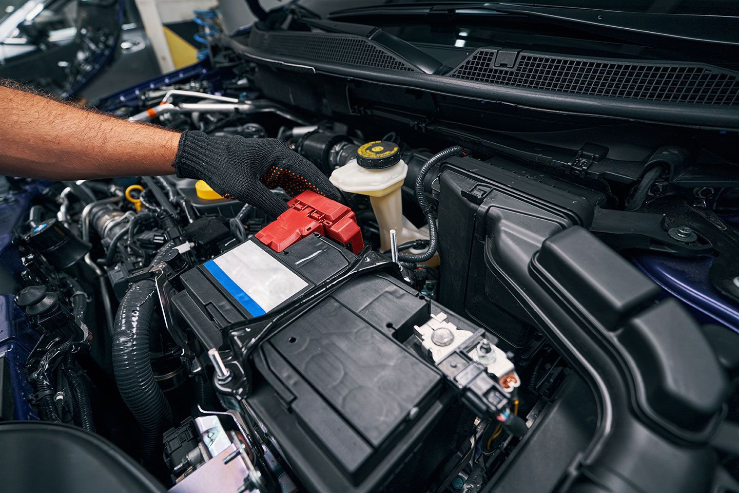 person-checking-the-car-battery-under-bonnet
