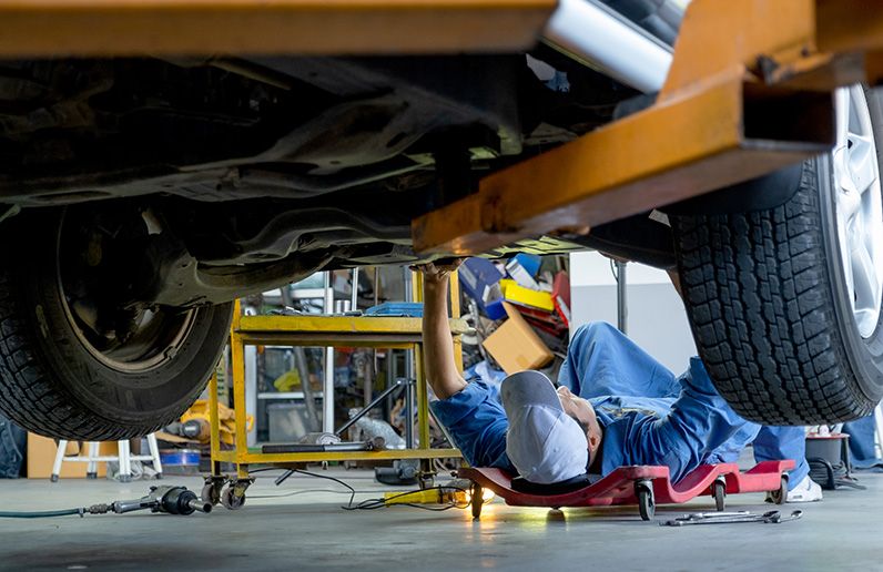 lower-view-under-car-garage-worker-or-technician