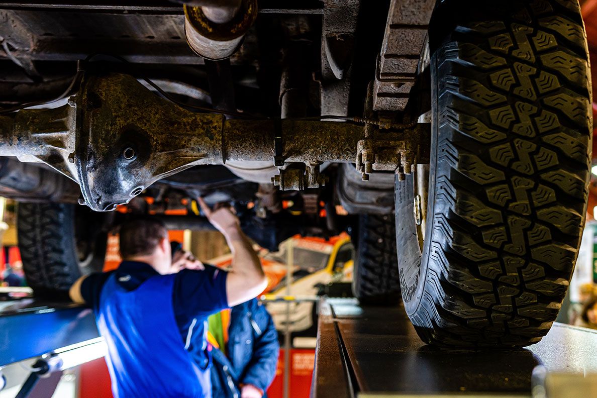 a-mechanic-is-checking-the-technical-state-underne