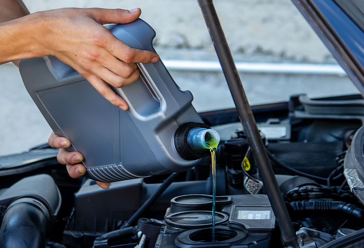 an-auto-mechanic-changing-oil-pours-oil-into-a-car-202