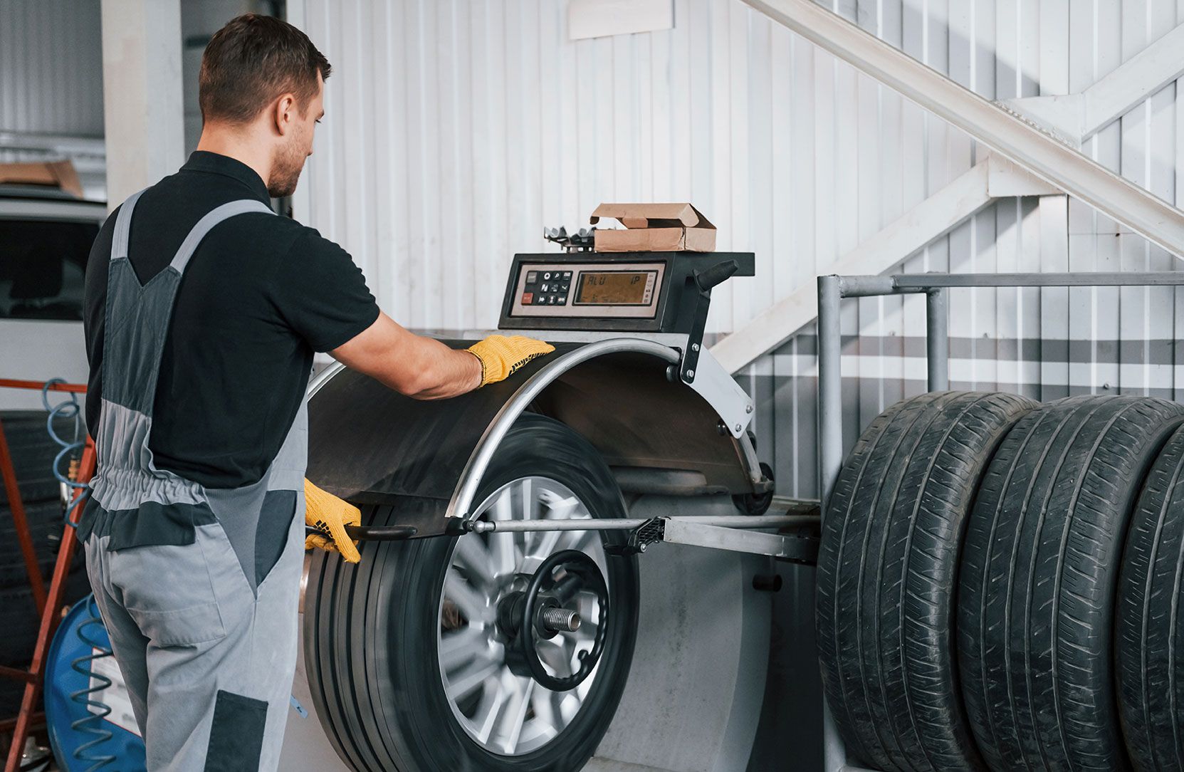 fixing-the-tire-man-in-uniform-is-working