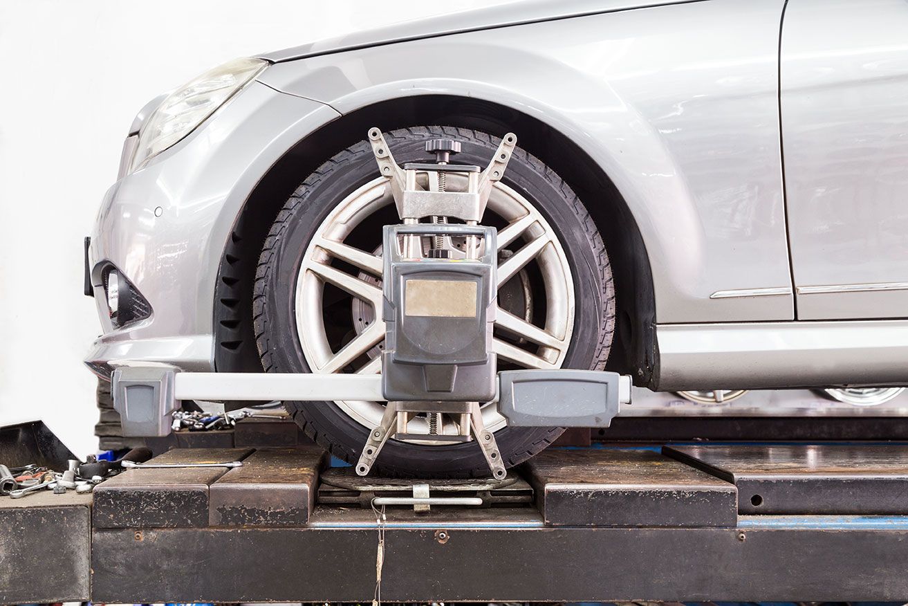 closeup-of-tire-clamped-with-aligner-undergoing