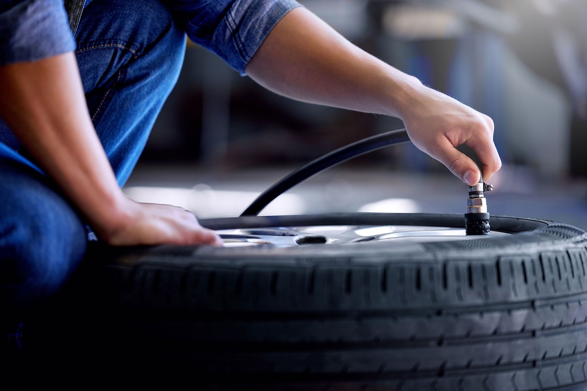 air-pressure-tire-and-mechanic-working-in-garage