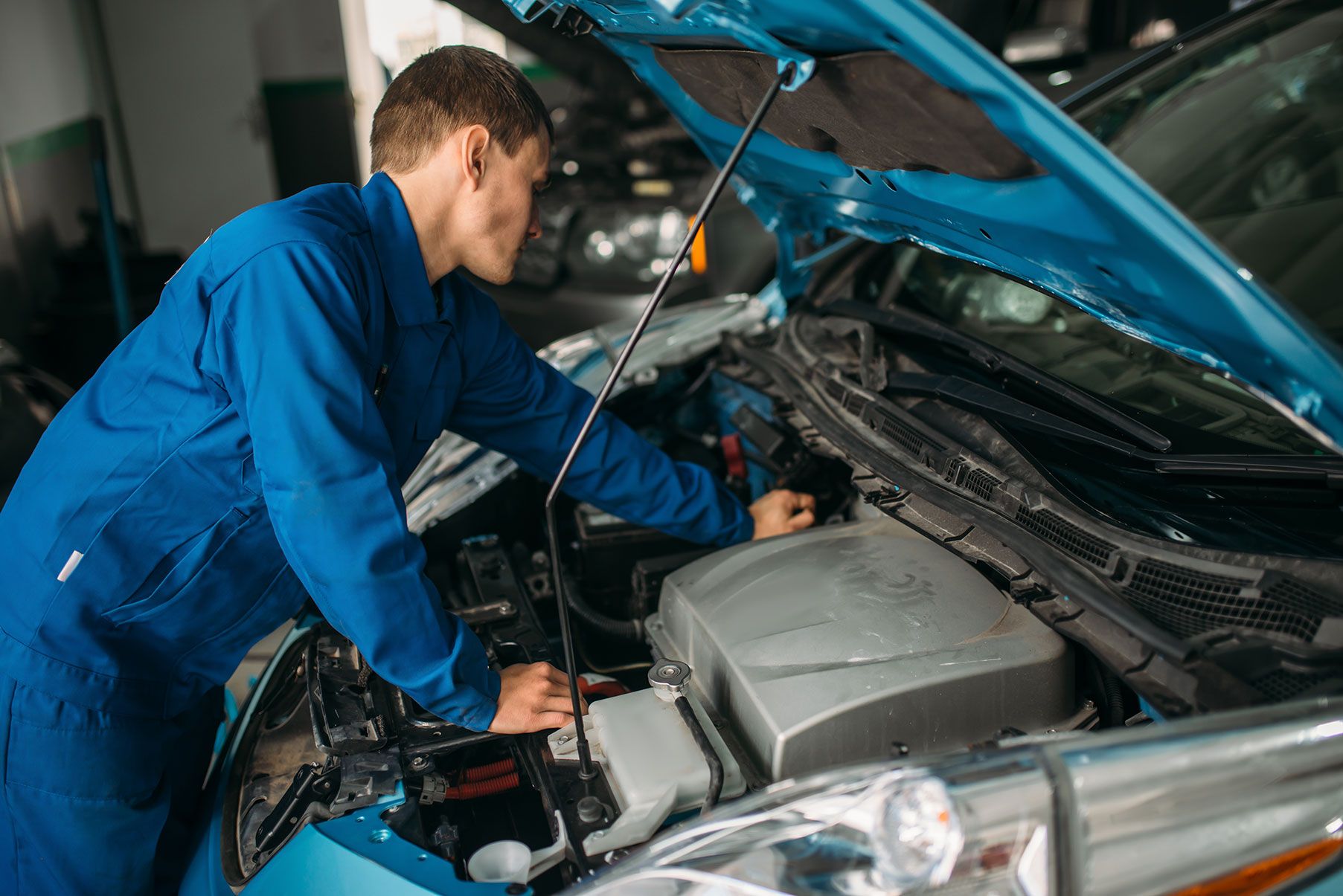 mechanic-repairs-car-engine-motor-diagnostic